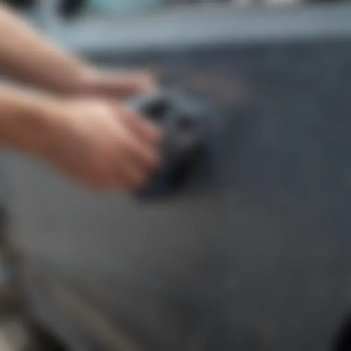 Person using a microfiber cloth to buff out scratches on a car door