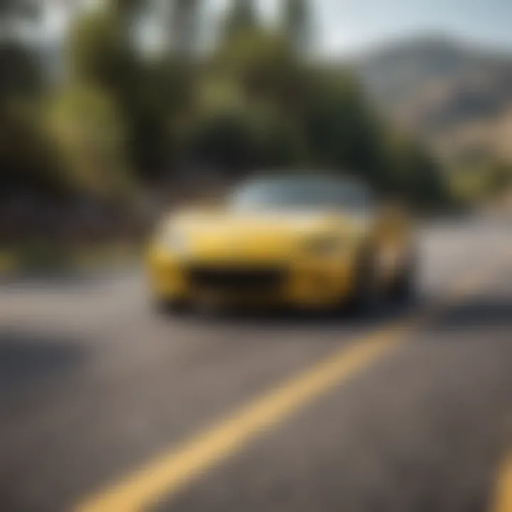 Yellow Mazda Miata on a winding road, emphasizing its performance