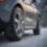 Close-up of a Mercedes vehicle fitted with premium snow tires on a snowy road.