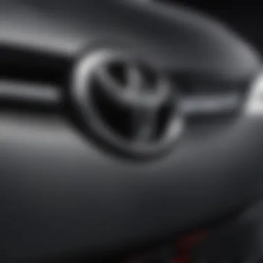 Close-up view of the Toyota Camry emblem highlighting various lighting options