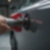 Close-up view of a specialized tool used in paintless door ding removal.