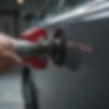 Close-up view of a specialized tool used in paintless door ding removal.