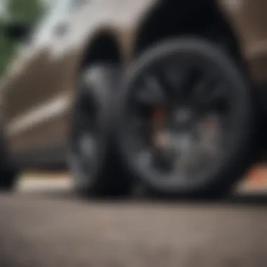 An all-season low profile tire mounted on a sporty vehicle in a dynamic driving setting