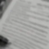 A close-up of a car insurance policy document with a pen