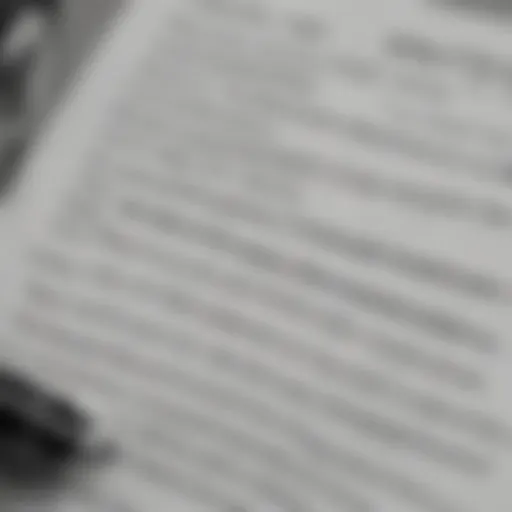 A close-up of a car insurance policy document with a pen