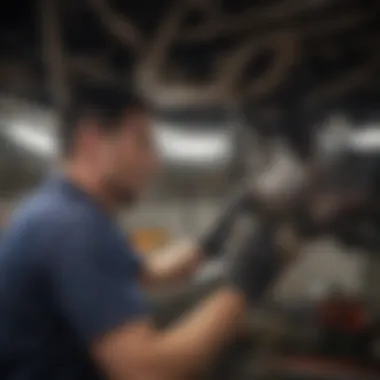Maintenance technician inspecting the catalytic converter of a Toyota Prius